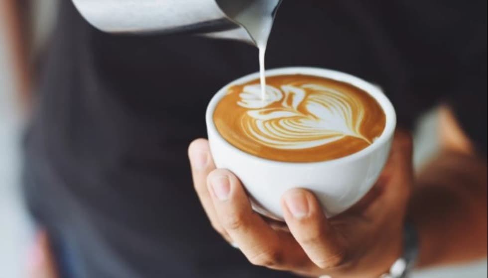Barista doing latte art in cup of coffee Barista doing latte art in cup of coffee
