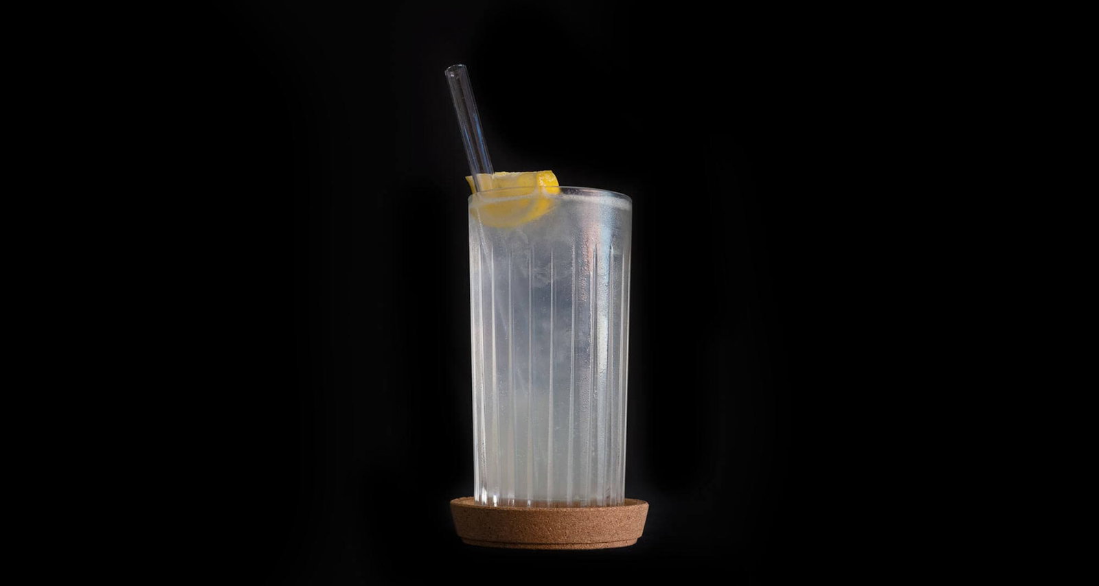 How to make a Tom Collins Cocktail Tom collins cocktail on black background